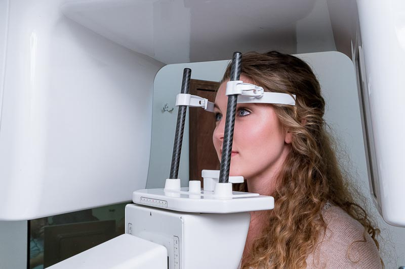 A young female patient at SOTA Dental in Los Algodones is getting a dental CT scan